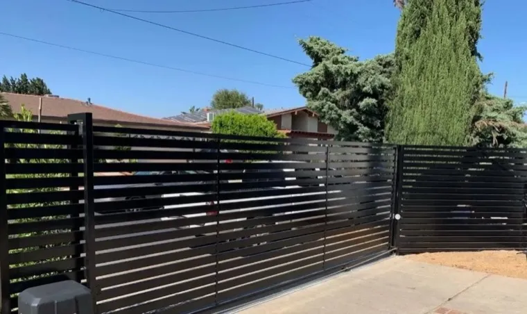 Black aluminum driveway gate installation and repair in Orange County, CA