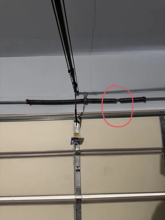 Snapped torsion spring on a garage door shaft — broken spring repair in Orange County, CA