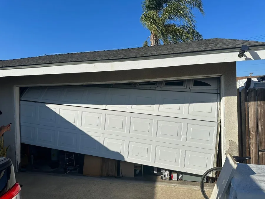 Garage door caved and slid sideways across the opening after a cable failure — when replacement beats repair in Orange County, CA