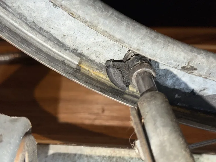 Frayed garage door lift cable with loose strands — cable repair in Orange County, CA