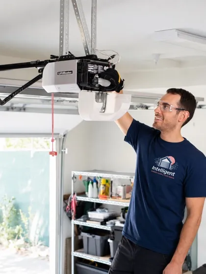 Technician mounting a garage door opener to the ceiling — garage door opener installation and repair in Orange County